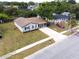Aerial shot of a quaint home with grey siding, complemented by a well-maintained lawn and private driveway at 7714 Lady Frances Way, Orlando, FL 32807