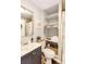 Cozy bathroom with linen storage, neutral walls, updated vanity, and decorative touches at 7714 Lady Frances Way, Orlando, FL 32807