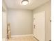 Entryway featuring tile flooring, a white front door, and a neutral color palette at 7714 Lady Frances Way, Orlando, FL 32807