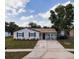 Charming single-story home with a well-maintained lawn, inviting porch, and a concrete driveway at 7714 Lady Frances Way, Orlando, FL 32807