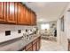 Charming kitchen with dark wood cabinets overlooking the dining room with laminate flooring at 7714 Lady Frances Way, Orlando, FL 32807