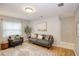 Cozy living room featuring a neutral color palette, hardwood floors, and stylish furniture arrangement at 7714 Lady Frances Way, Orlando, FL 32807
