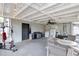 Covered outdoor patio with ceiling fan, string lights, and outdoor seating at 7714 Lady Frances Way, Orlando, FL 32807