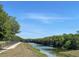 Scenic view of a tranquil canal, perfect for a relaxing walk or enjoying nature's beauty at 7714 Lady Frances Way, Orlando, FL 32807