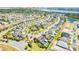 Aerial view of neighborhood showcasing community layout, home styles, landscaping and pond views at 8384 Ludington Cir, Orlando, FL 32836