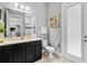 Bright bathroom with modern vanity, framed mirror, stylish fixtures, and glass enclosed shower at 8384 Ludington Cir, Orlando, FL 32836