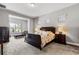 Spacious bedroom featuring large bed, sitting area with lots of natural light, and neutral colors at 8384 Ludington Cir, Orlando, FL 32836