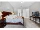 Bedroom features a patterned bedspread, a wall-mounted television and neutral colors at 8384 Ludington Cir, Orlando, FL 32836