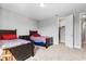 Bright bedroom with two twin beds, a walk-in closet, and neutral walls creating a cozy atmosphere at 8384 Ludington Cir, Orlando, FL 32836