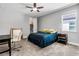 Comfortable bedroom with a ceiling fan, closet, desk, and a bright window offering natural light at 8384 Ludington Cir, Orlando, FL 32836