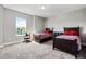 Charming bedroom featuring two twin beds with matching red and plaid bedding, and a large window at 8384 Ludington Cir, Orlando, FL 32836