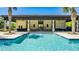 Large community pool with turquoise blue water and a covered lounge area with ceiling fans at 8384 Ludington Cir, Orlando, FL 32836