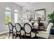 Formal dining room with a sparkling chandelier and a large mirror at 8384 Ludington Cir, Orlando, FL 32836