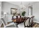 Elegant dining room featuring a crystal chandelier, stylish chairs, and natural light at 8384 Ludington Cir, Orlando, FL 32836