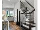 Home Foyer features dark wood floors, wooden staircase, and lots of natural light at 8384 Ludington Cir, Orlando, FL 32836