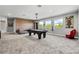 The game room boasts a billiard table, a brick wall and several windows with natural light at 8384 Ludington Cir, Orlando, FL 32836