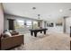 Game room features a billiard table, comfortable seating, and lots of light at 8384 Ludington Cir, Orlando, FL 32836