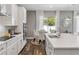 Modern kitchen with white cabinets, quartz countertops, stainless steel appliances, and eat in dining area at 8384 Ludington Cir, Orlando, FL 32836