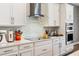 Contemporary kitchen with white cabinetry, quartz countertops, and stainless steel appliances at 8384 Ludington Cir, Orlando, FL 32836