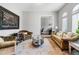 Cozy living room featuring sofas, decorative rug, and an adjoining office at 8384 Ludington Cir, Orlando, FL 32836
