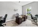 Well-lit home office with neutral walls, a desk, and office chairs at 8384 Ludington Cir, Orlando, FL 32836