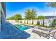 Scenic backyard with a pool and chaise lounge chairs, offering a relaxing outdoor space at 8384 Ludington Cir, Orlando, FL 32836