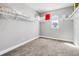 Well-lit walk-in closet with carpeted floors, shelving, and a window for added natural light at 8384 Ludington Cir, Orlando, FL 32836