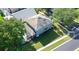 Aerial view of home featuring a screened-in pool, spacious yard, and mature trees at 8500 Palm Harbour Dr, Kissimmee, FL 34747