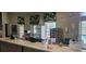 A bar area with a white countertop, pizza oven, beverage cooler and decorative window treatments at 8500 Palm Harbour Dr, Kissimmee, FL 34747