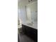 Bathroom featuring a large mirror, granite countertop, dark cabinets and tile flooring at 8500 Palm Harbour Dr, Kissimmee, FL 34747