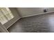 Bedroom with gray wood-look flooring and a window bringing in natural light at 8500 Palm Harbour Dr, Kissimmee, FL 34747