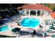 Resort-style community pool with lounge chairs, umbrellas, and a spacious deck area at 8500 Palm Harbour Dr, Kissimmee, FL 34747