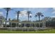 Community entrance features fountain with palm trees and vibrant landscaping creating a welcoming gateway at 8500 Palm Harbour Dr, Kissimmee, FL 34747