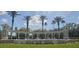 Community entrance features fountain with palm trees and vibrant landscaping creating a welcoming gateway at 8500 Palm Harbour Dr, Kissimmee, FL 34747