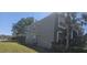 Charming two-story home featuring well-maintained landscaping, mature palm trees, and a side entry garage at 8500 Palm Harbour Dr, Kissimmee, FL 34747