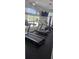 Community gym features modern treadmills, stationary bike, and elliptical near a pool area at 8500 Palm Harbour Dr, Kissimmee, FL 34747