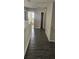 Second floor hallway with gray walls and gray wood flooring overlooking the first floor at 8500 Palm Harbour Dr, Kissimmee, FL 34747