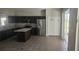 The kitchen is equipped with granite countertops, stainless steel appliances, and dark wood cabinets at 8500 Palm Harbour Dr, Kissimmee, FL 34747