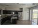 The kitchen is equipped with granite countertops, stainless steel appliances, and dark wood cabinets at 8500 Palm Harbour Dr, Kissimmee, FL 34747