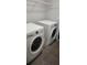 A functional laundry room featuring a washer, dryer, and wire shelving for convenient storage at 8500 Palm Harbour Dr, Kissimmee, FL 34747