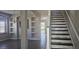 A stylishly designed interior, features decorative columns, a window seat, and a staircase with unique stone accents at 8500 Palm Harbour Dr, Kissimmee, FL 34747