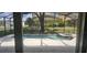 A screen enclosed pool with a connected hot tub and view of neighboring backyards at 8500 Palm Harbour Dr, Kissimmee, FL 34747