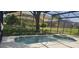 A screen enclosed pool with a connected hot tub and view of neighboring backyards at 8500 Palm Harbour Dr, Kissimmee, FL 34747