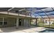 A screened in pool with a covered lanai and a view of the backyard at 8500 Palm Harbour Dr, Kissimmee, FL 34747