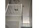 White bannister railing looking up to the ceiling and light fixture in a stairwell at 8500 Palm Harbour Dr, Kissimmee, FL 34747