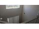 Looking from the top of the stairs, the stairwell is bright with natural light at 8500 Palm Harbour Dr, Kissimmee, FL 34747