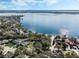 Breathtaking aerial view of lakefront homes and pristine blue waters with lush trees and a clear sky at 9676 Wild Oak Dr, Windermere, FL 34786