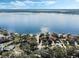 Panoramic aerial view capturing lakefront homes with sparkling blue waters and a clear, sunny sky at 9676 Wild Oak Dr, Windermere, FL 34786