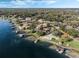 Lakefront homes with boat docks along the lush shoreline, captured in a scenic aerial view with blue waters at 9676 Wild Oak Dr, Windermere, FL 34786