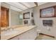 Bright bathroom featuring double sinks with granite countertops and tiled walk-in shower at 9676 Wild Oak Dr, Windermere, FL 34786